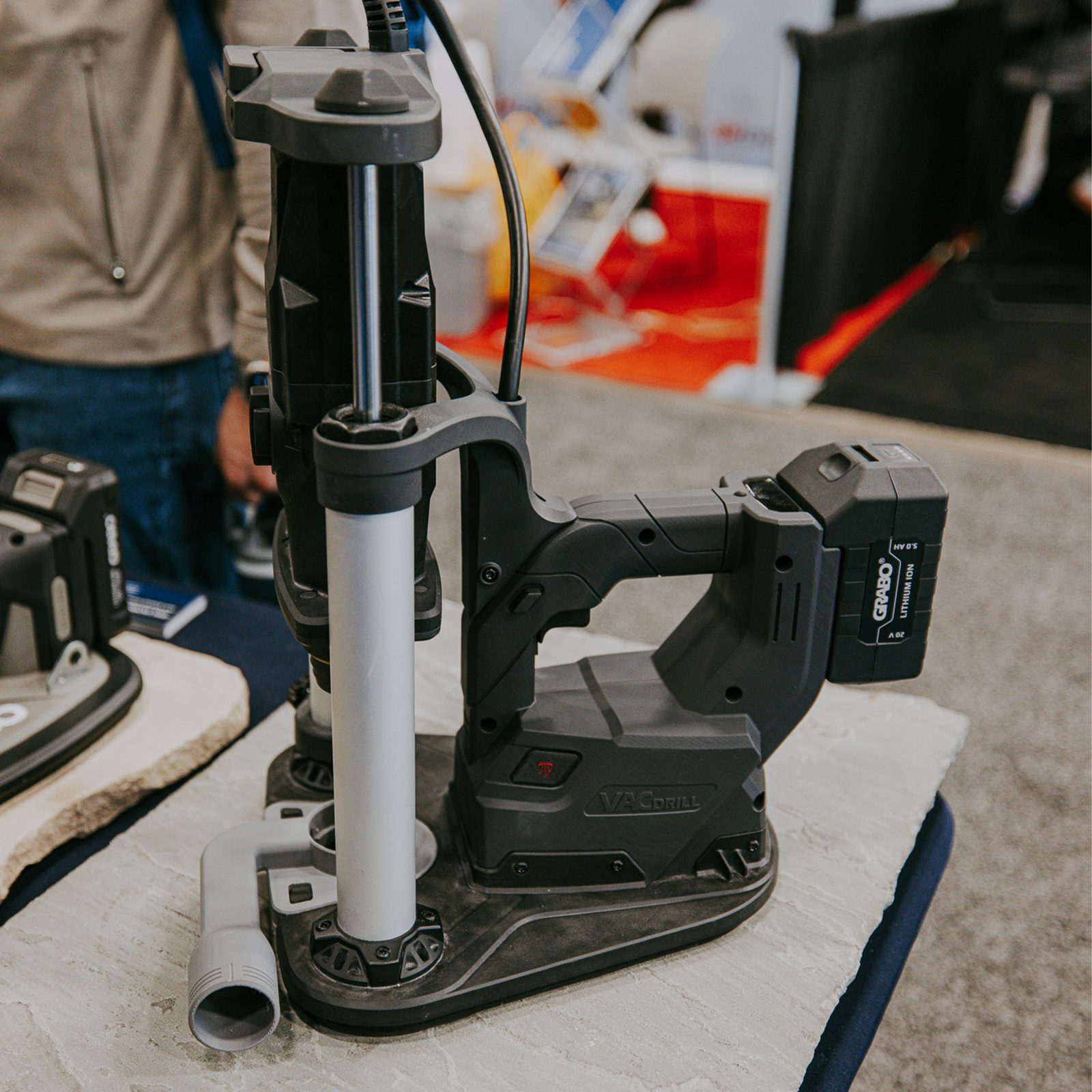 GRABO VACDRILL vacuum-anchored to a stone slab with dust extraction port and 20V 5.0Ah battery